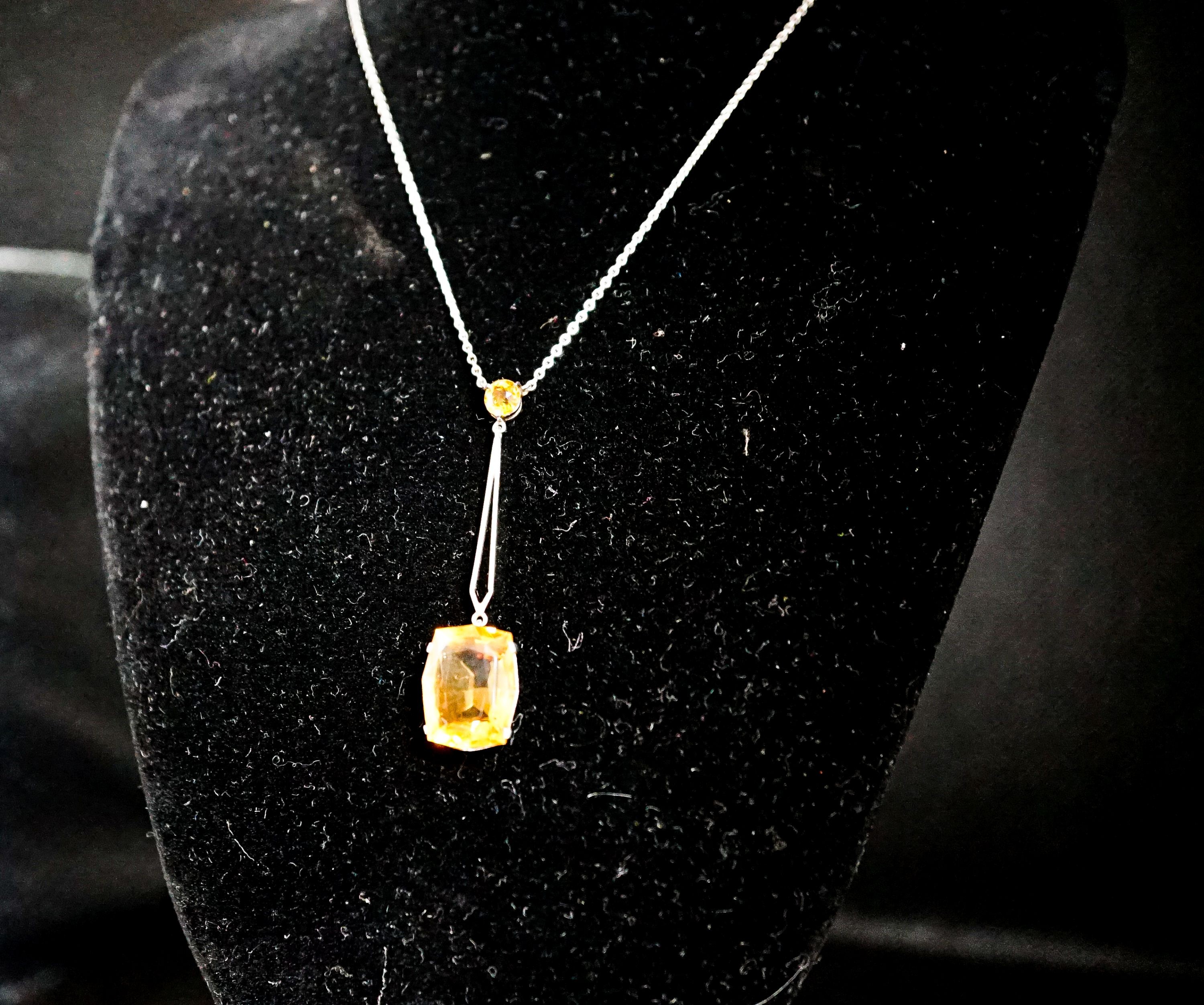 A white metal and two stone citrine set drop line pendant necklace, pendant 45mm, chain 40cm, gross weight 4.1 grams.